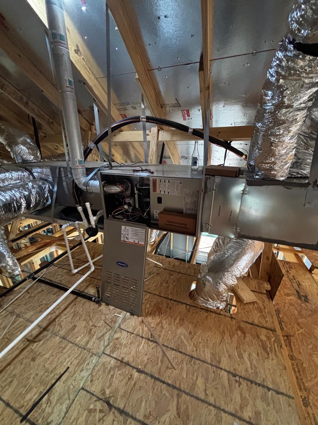 An attic HVAC furnace and ductwork checked during a re-inspection to verify prior repairs were completed correctly.