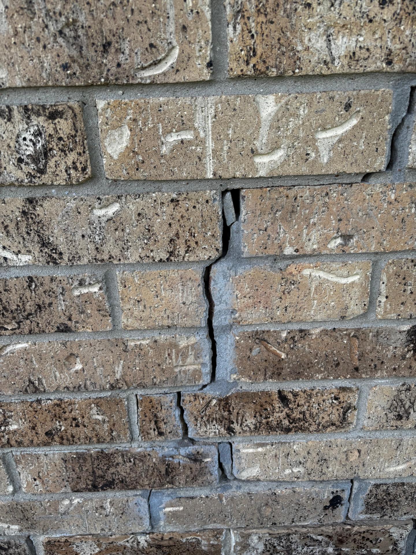 A crack in a brick foundation wall found during a buyer's home inspection.