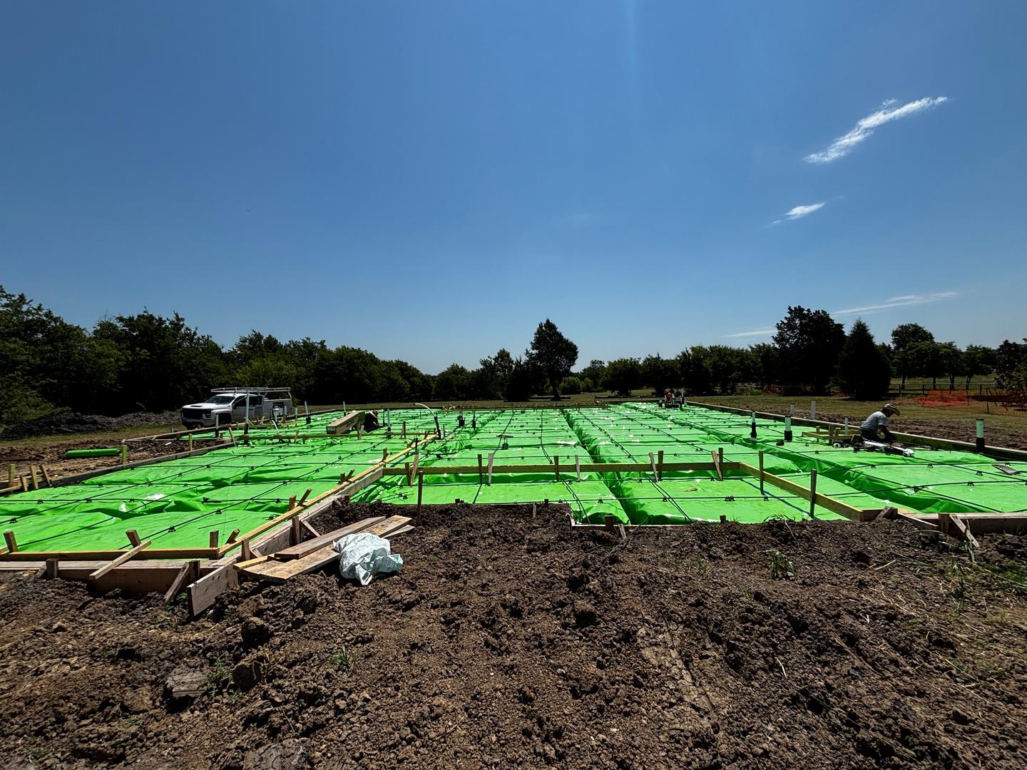 A foundation pre-pour inspection showing the vapor barrier and cable grid before concrete is poured.
