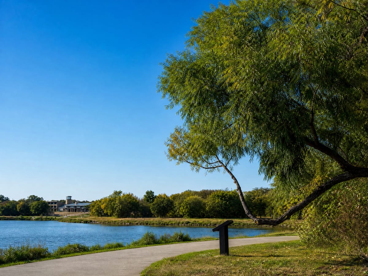 A paved lakeside walking trail along the shoreline in Oak Point, TX.