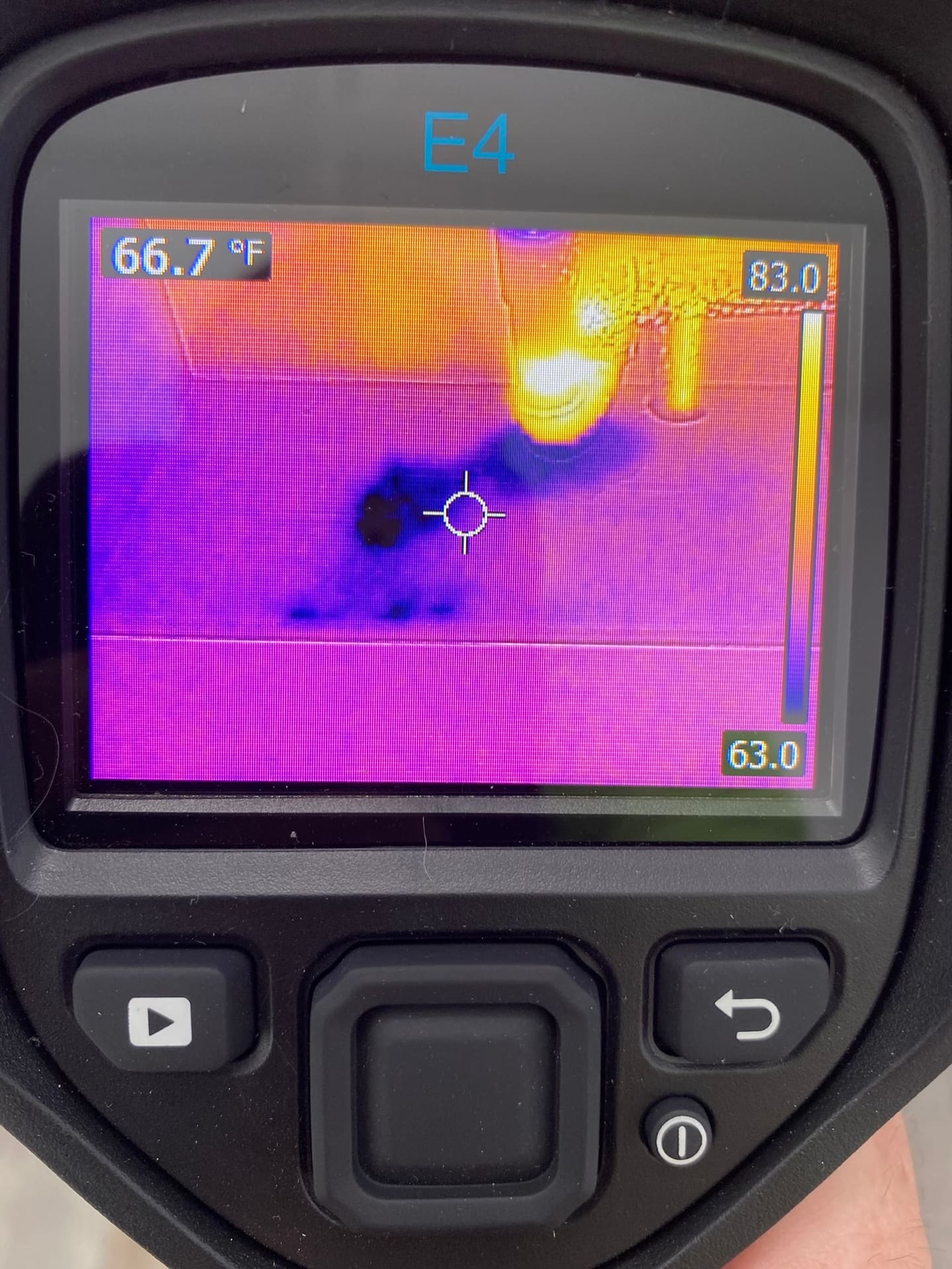 A thermal imaging camera checking ceiling insulation during a home maintenance inspection.